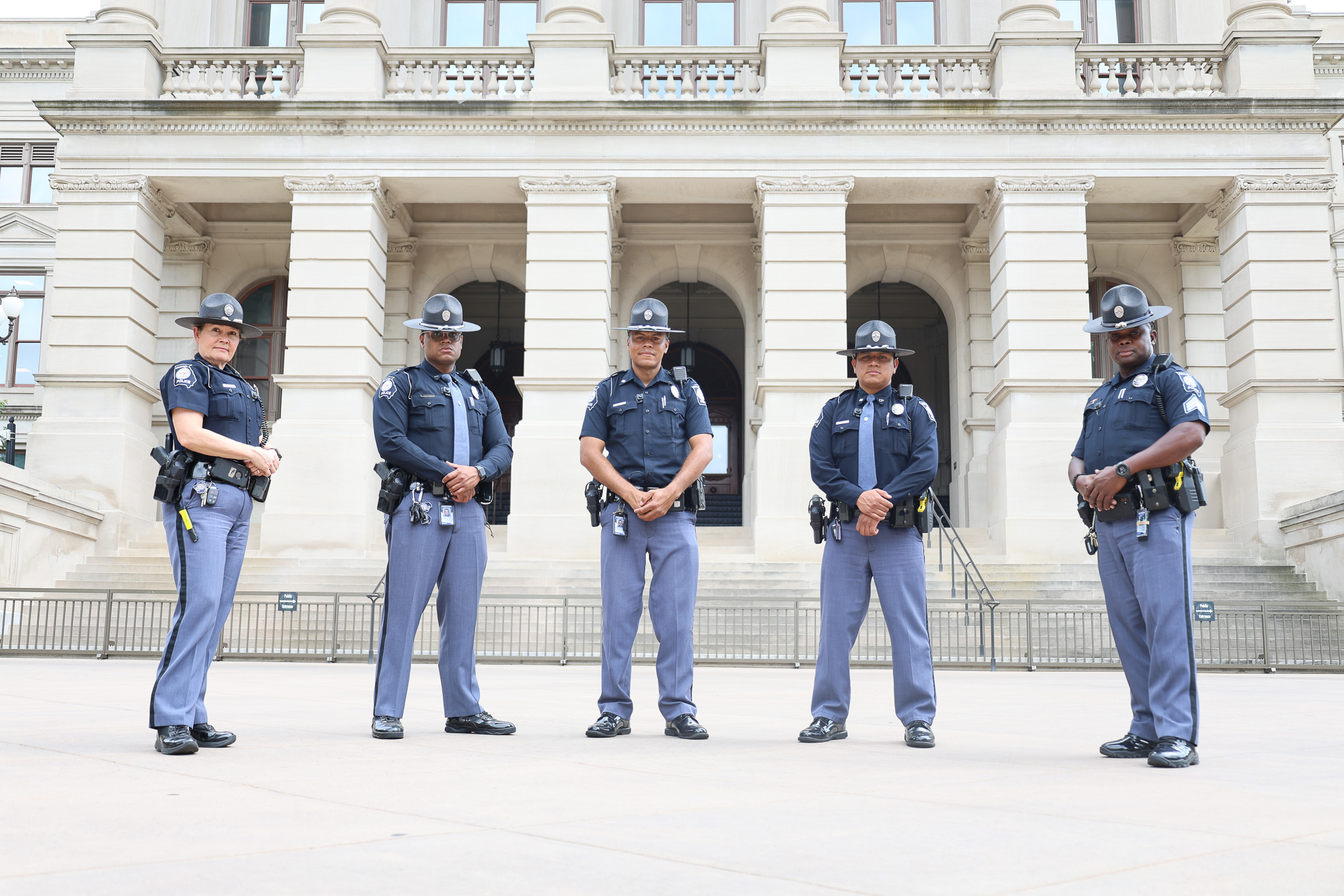 Five Capitol Police officers standing in front of the Georgia State Capitol building